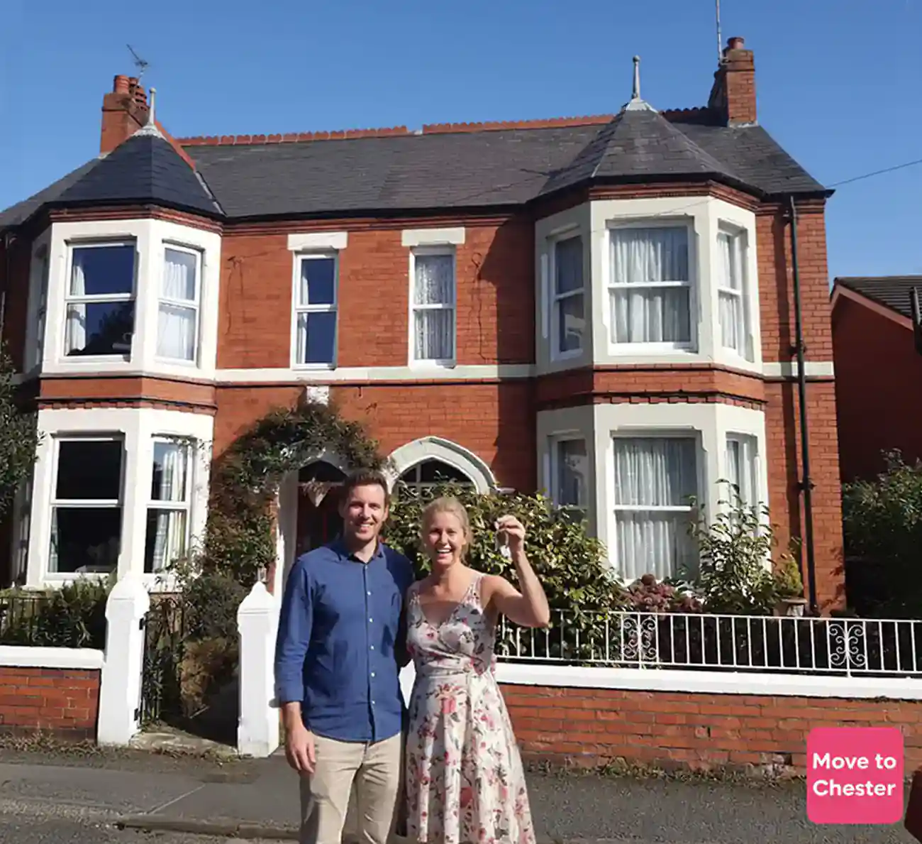 Happy family standing in front of their new Chester home after successful relocation